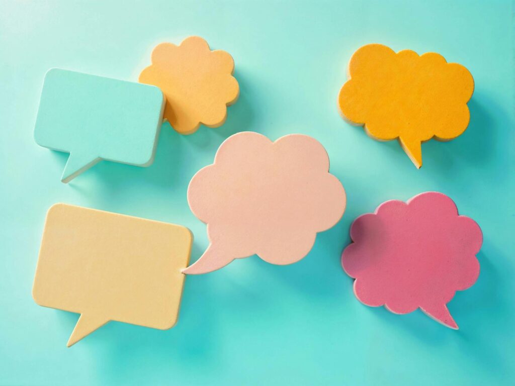 Bright pastel speech bubbles on a blue background, ideal for communication themes.